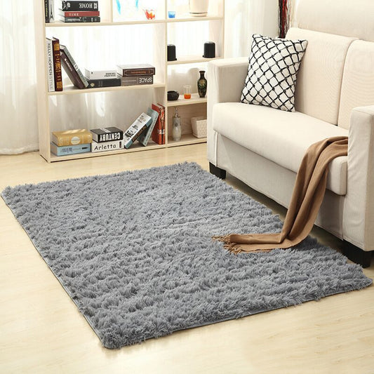 Soft carpet spread in a cozy living room with a sofa and coffee table beside a sunny bedroom corner



