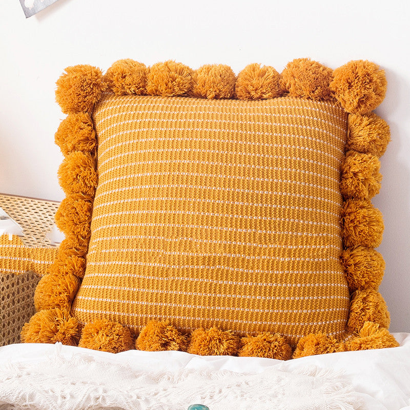 Knitted waist pillowcase on a neutral-toned bed with cozy decorative pillows

