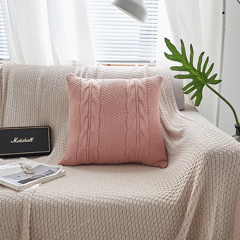 Natural wool pillow placed on a bed with neutral, minimalist bedding

