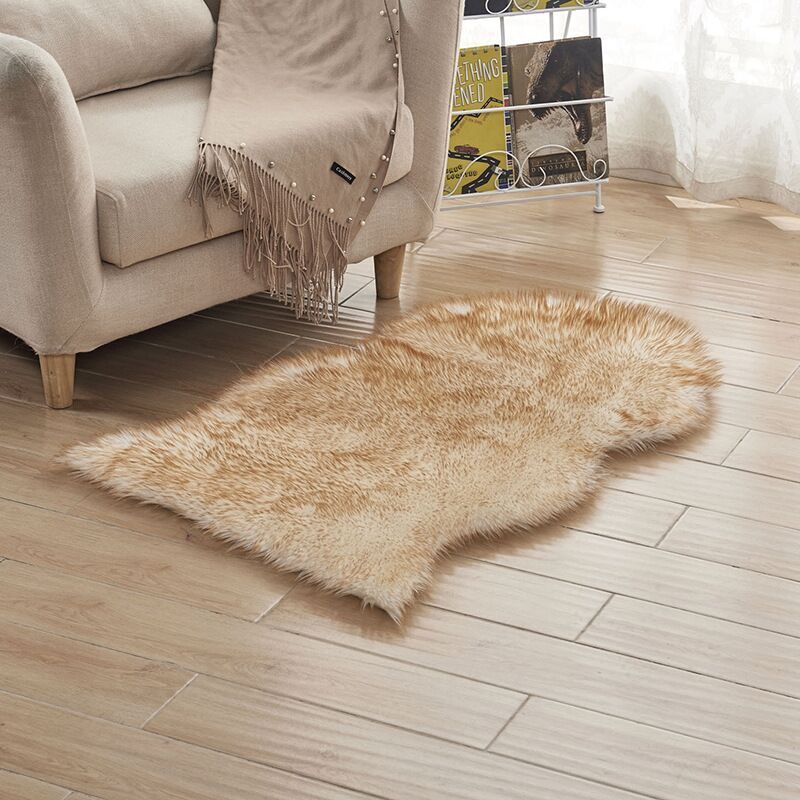 Plush carpet floor mat placed in a bedroom near the bed on a wooden floor

