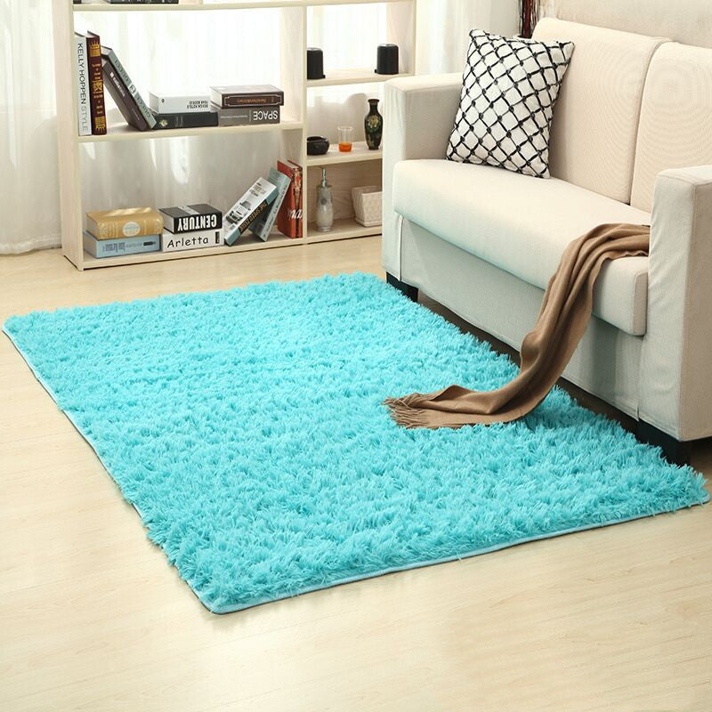 Soft carpet spread in a cozy living room with a sofa and coffee table beside a sunny bedroom corner

