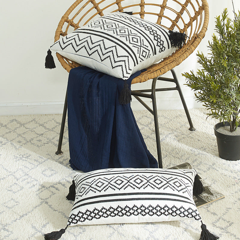 Nordic Moroccan chenille geometric throw pillow with tassels on a modern sofa

