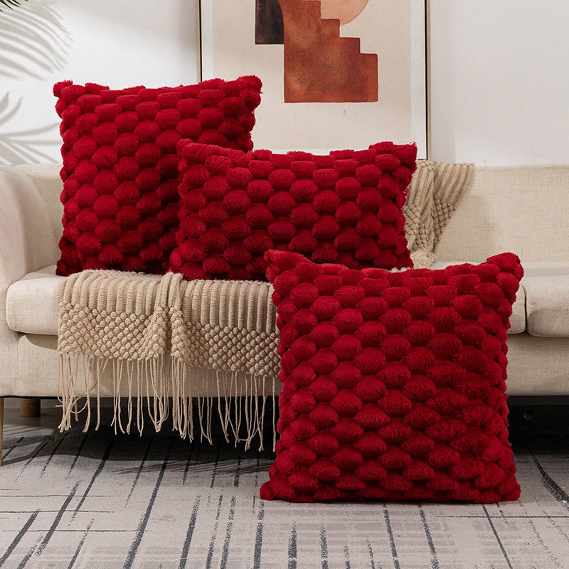 Woven fleece solid color waist pillow cover on a soft grey sofa in a cozy room

