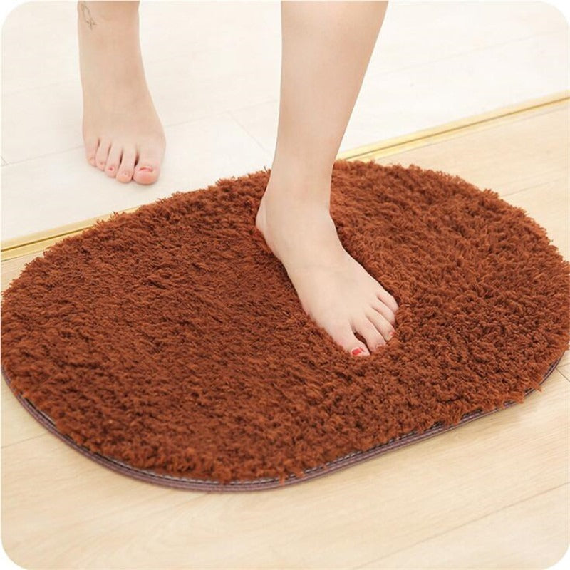 Oval-shaped absorbent carpet in a modern living room with light furniture and natural lighting

