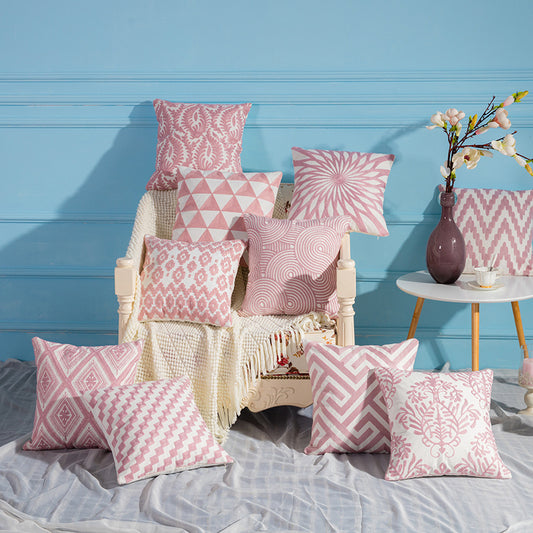 Geometric embroidered cotton pillowcase on a modern sofa with decorative cushions

