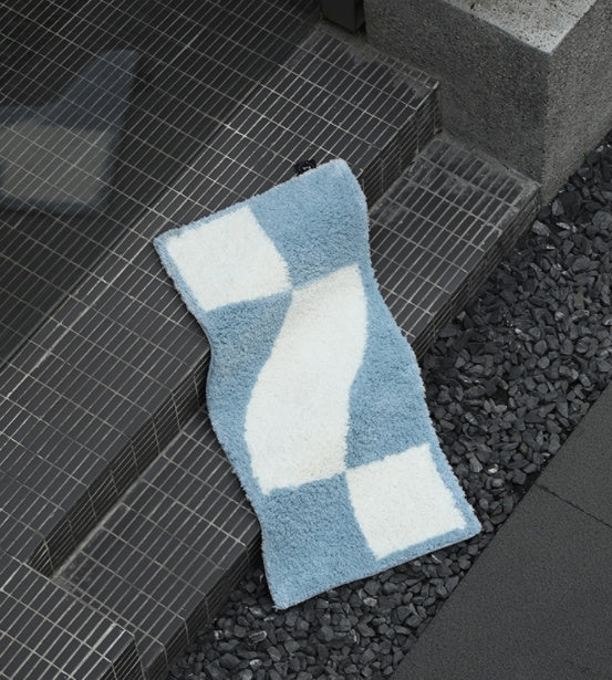 Checkered flocked home carpet in a minimalist living room with a soft grey and white pattern

