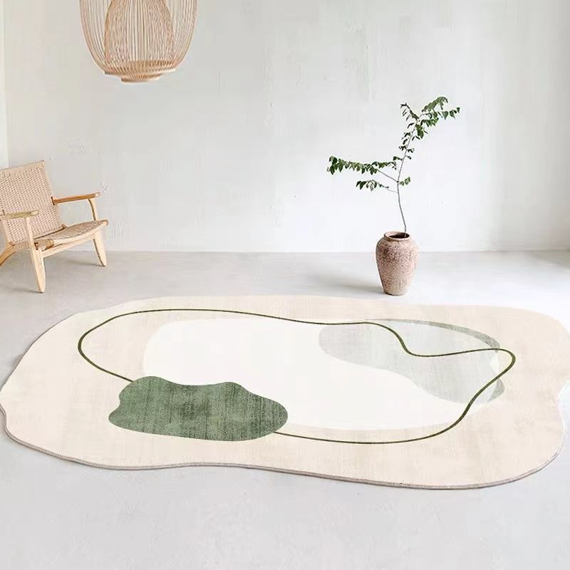 Irregular shaped carpet placed under a coffee table in a modern living room with artistic décor

