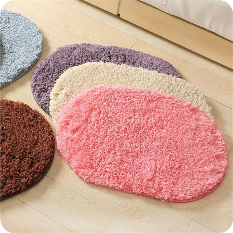 Oval-shaped absorbent carpet in a modern living room with light furniture and natural lighting


