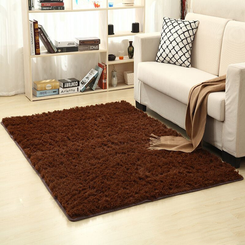 Soft carpet spread in a cozy living room with a sofa and coffee table beside a sunny bedroom corner

