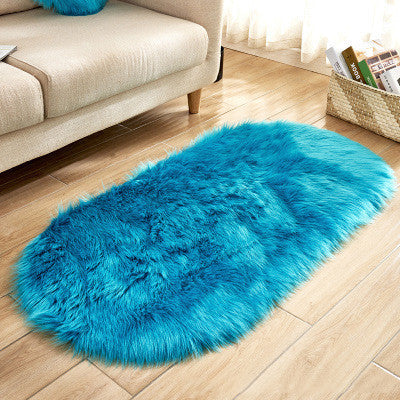 Oval wool-like carpet placed in a bedroom near the bed with cozy home décor

