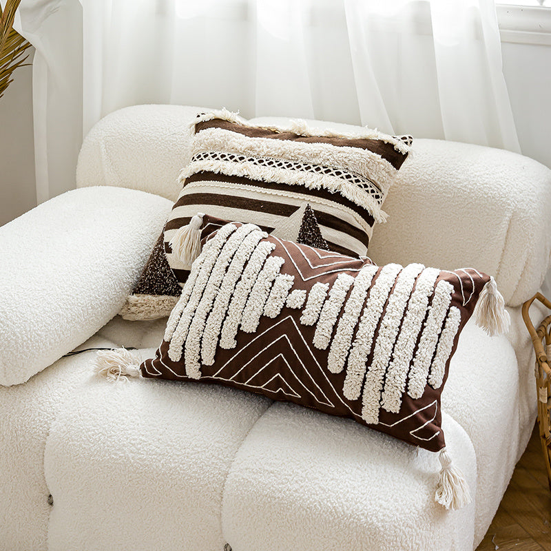 Nordic-style decorative cushion on a minimalist sofa with neutral tones
