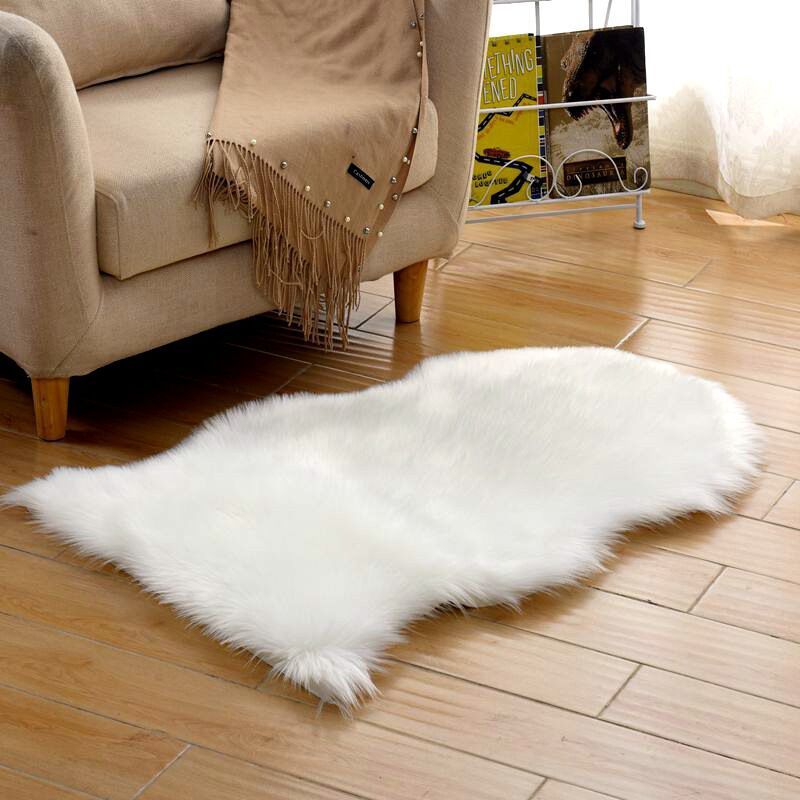 Plush carpet floor mat placed in a bedroom near the bed on a wooden floor

