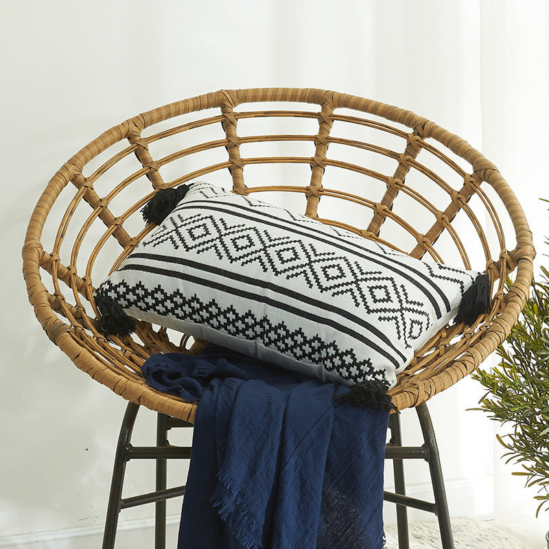 Nordic Moroccan chenille geometric throw pillow with tassels on a modern sofa

