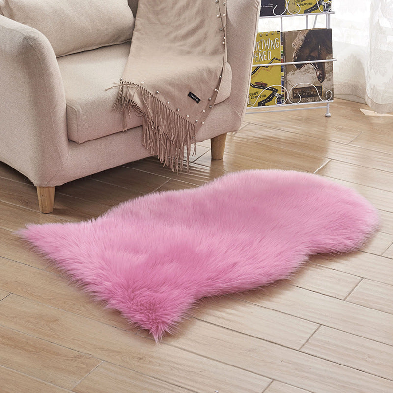 Plush carpet floor mat placed in a bedroom near the bed on a wooden floor

