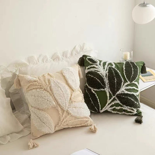 Tufted leaf design throw pillow on a neutral-toned sofa in a cozy living room

