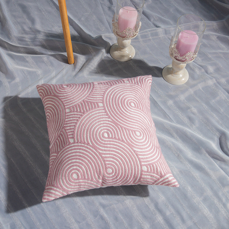 Geometric embroidered cotton pillowcase on a modern sofa with decorative cushions

