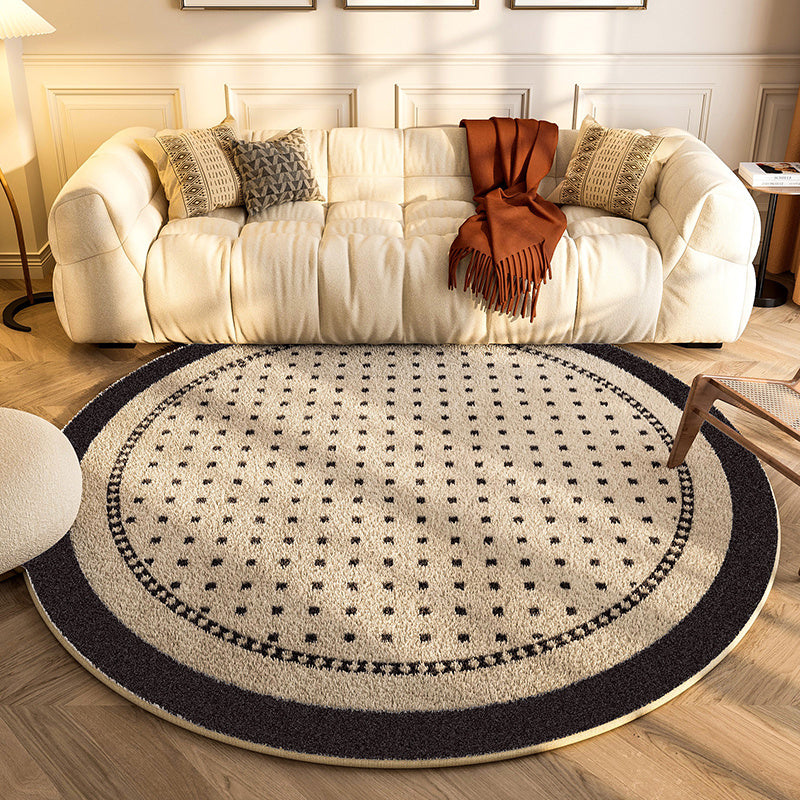 New round carpet placed in a modern living room under a coffee table with neutral décor

