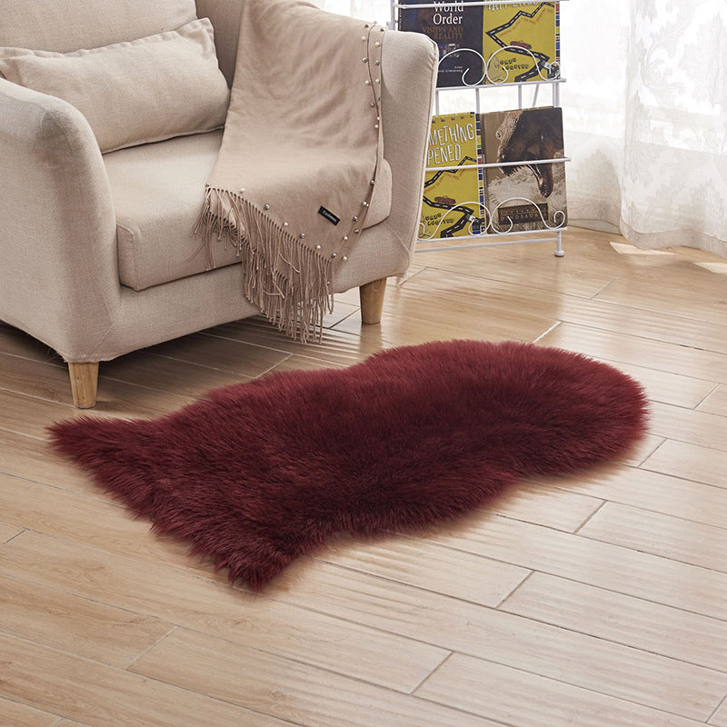 Plush carpet floor mat placed in a bedroom near the bed on a wooden floor

