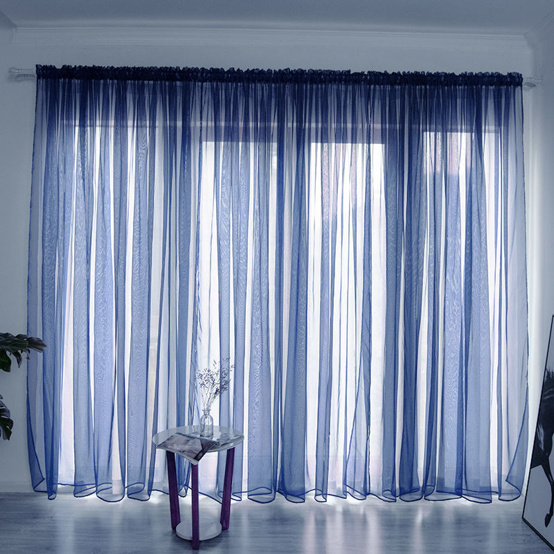 Modern solid color sheer gauze curtain on a balcony window filtering soft light

