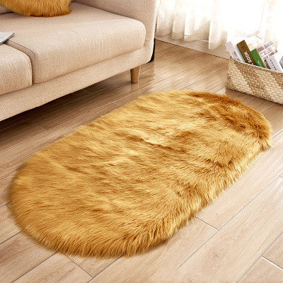 Oval wool-like carpet placed in a bedroom near the bed with cozy home décor


