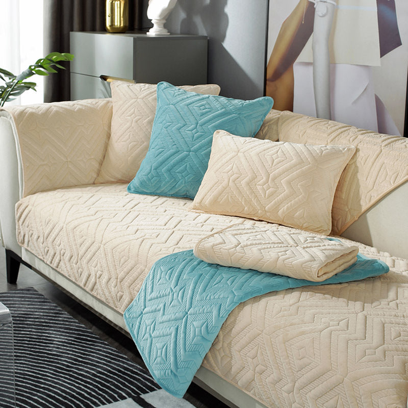 Black plush winter sofa cushion on a leather sofa with thick quilted texture

