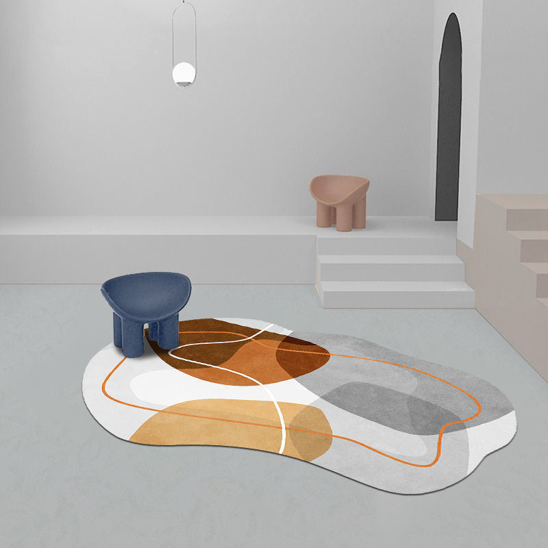 Irregular shaped carpet placed under a coffee table in a modern living room with artistic décor

