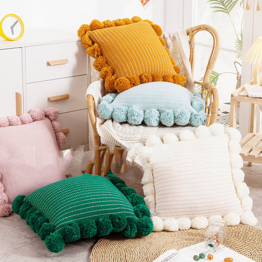 Knitted waist pillowcase on a neutral-toned bed with cozy decorative pillows

