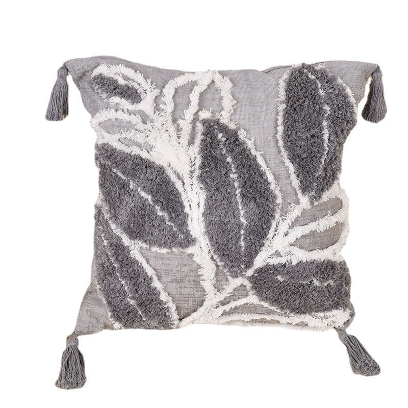 Tufted leaf design throw pillow on a neutral-toned sofa in a cozy living room

