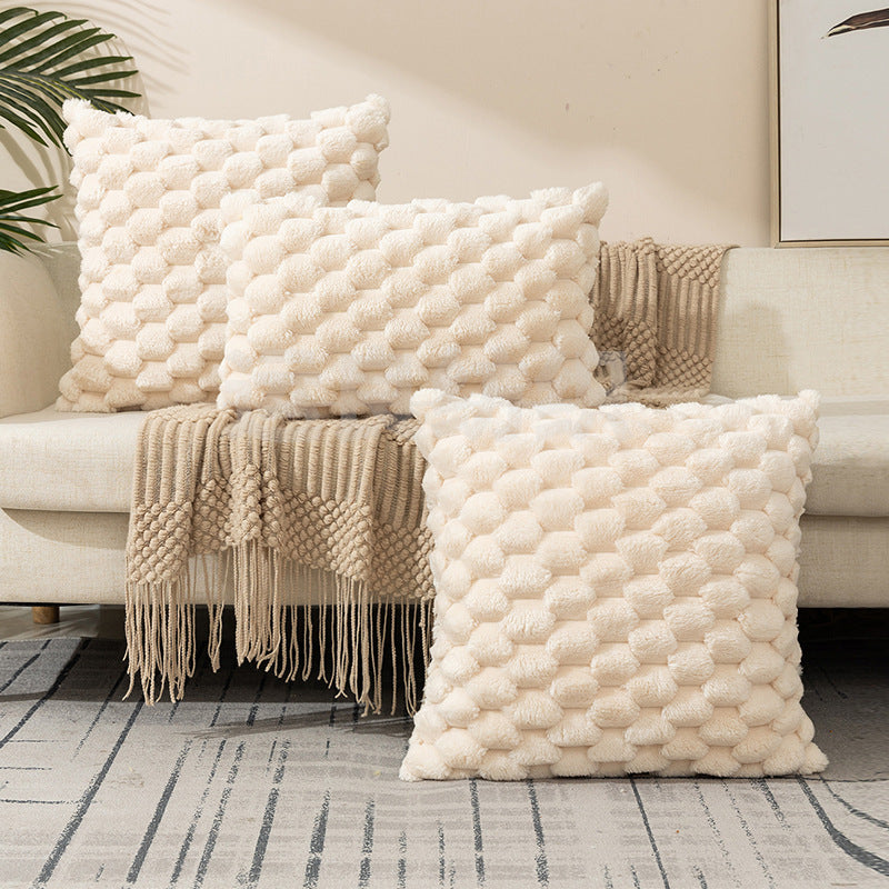 Woven fleece solid color waist pillow cover on a soft grey sofa in a cozy room


