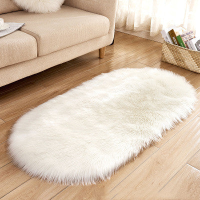 Oval wool-like carpet placed in a bedroom near the bed with cozy home décor

