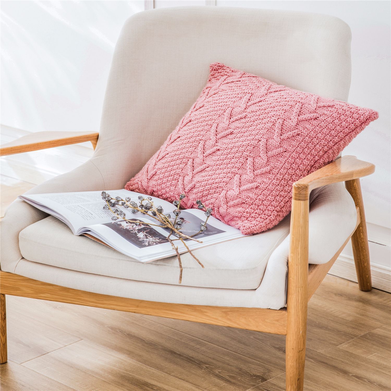 Thick wool knitted pillowcase with chunky knit pattern on a cozy sofa

