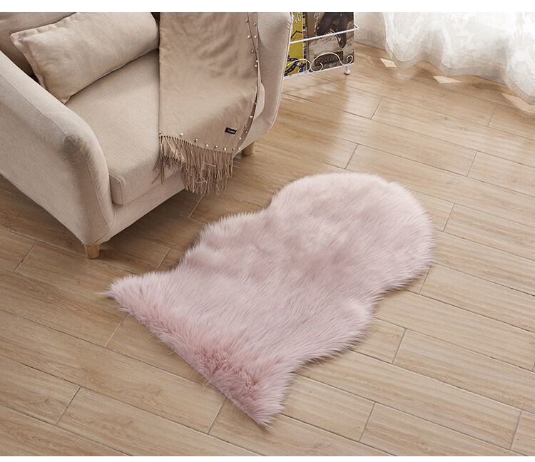 Plush carpet floor mat placed in a bedroom near the bed on a wooden floor

