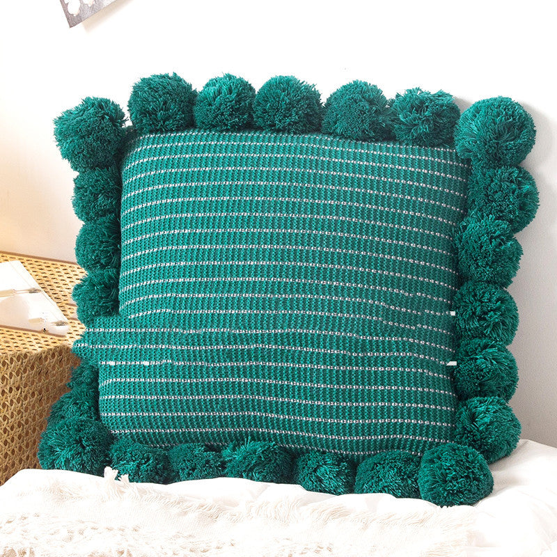 Knitted waist pillowcase on a neutral-toned bed with cozy decorative pillows

