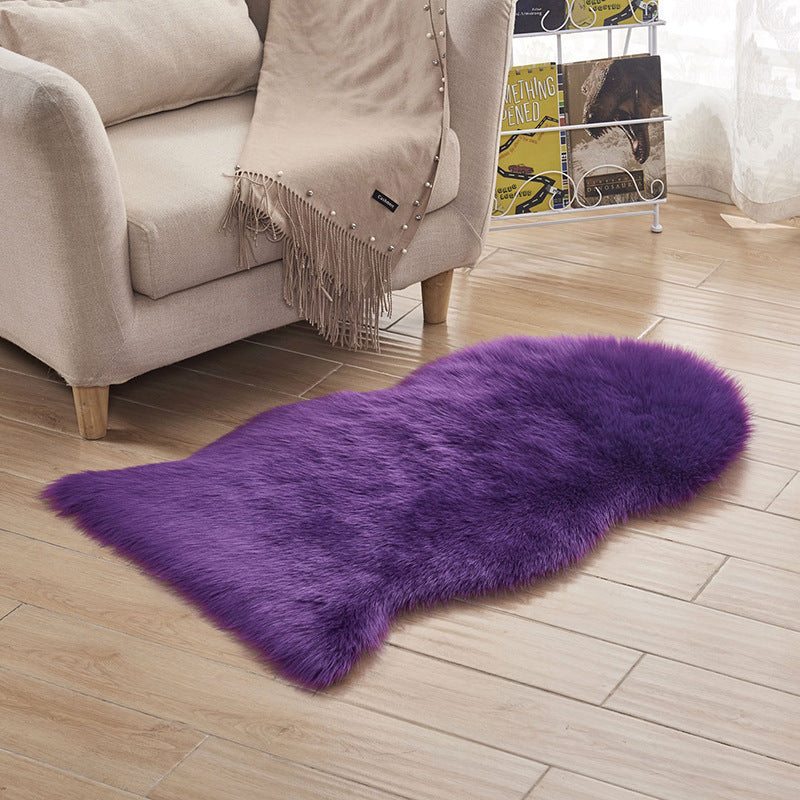 Plush carpet floor mat placed in a bedroom near the bed on a wooden floor

