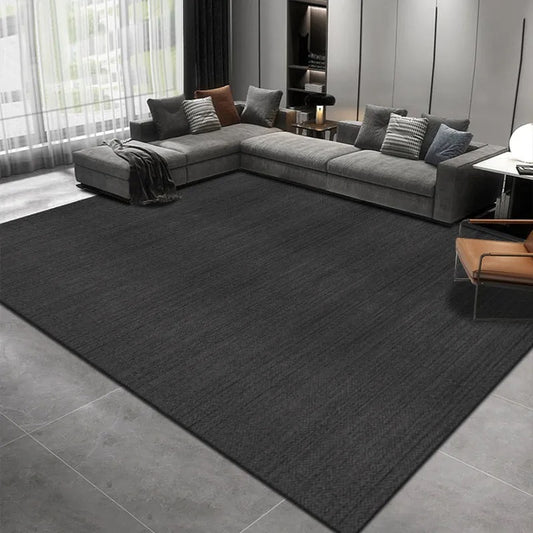 Solid color carpet under a coffee table in a modern living room with neutral tones and cozy accents

