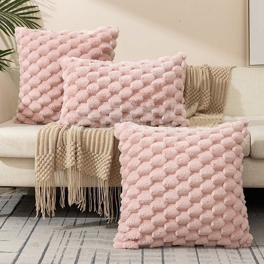 Woven fleece solid color waist pillow cover on a soft grey sofa in a cozy room

