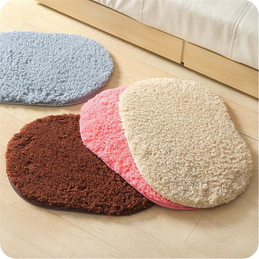Oval-shaped absorbent carpet in a modern living room with light furniture and natural lighting

