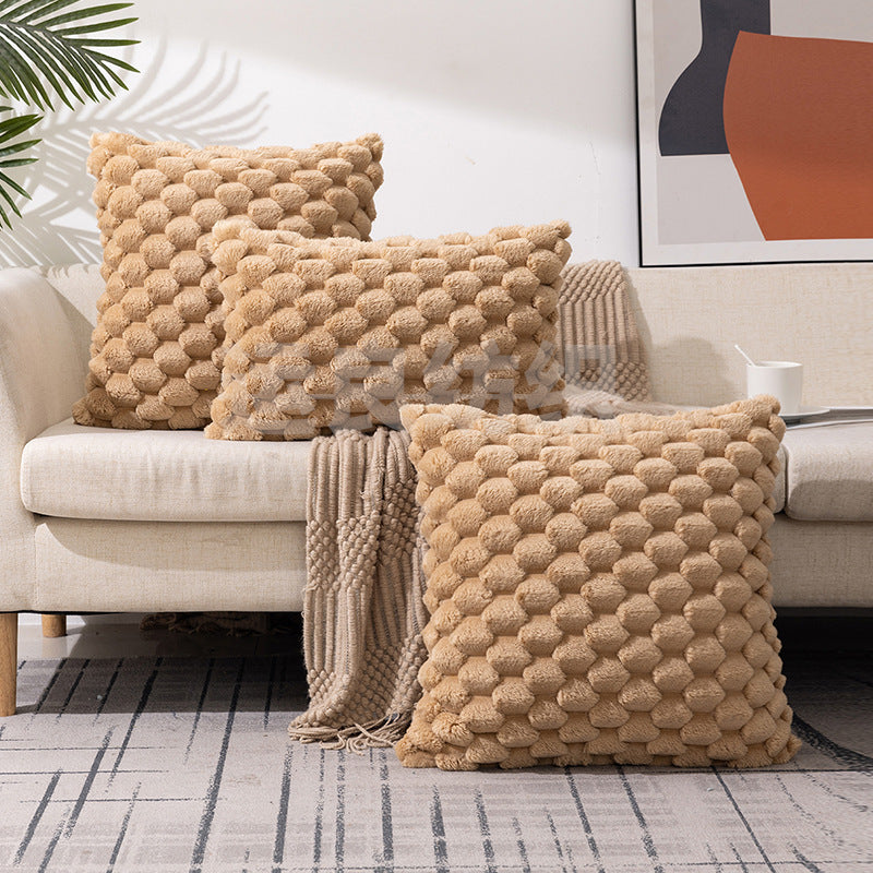 Woven fleece solid color waist pillow cover on a soft grey sofa in a cozy room

