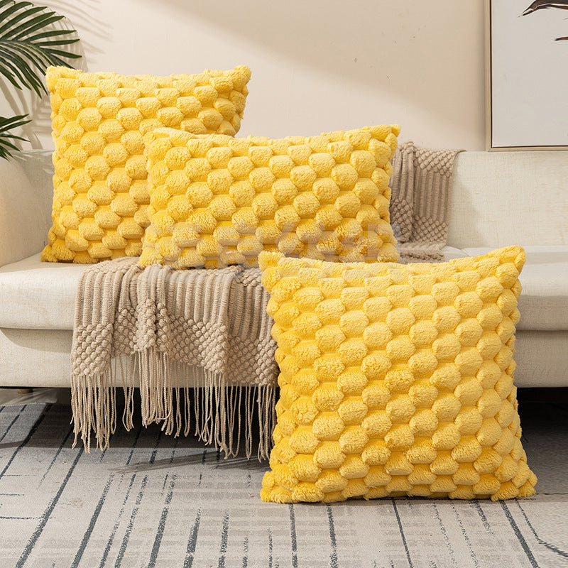 Woven fleece solid color waist pillow cover on a soft grey sofa in a cozy room

