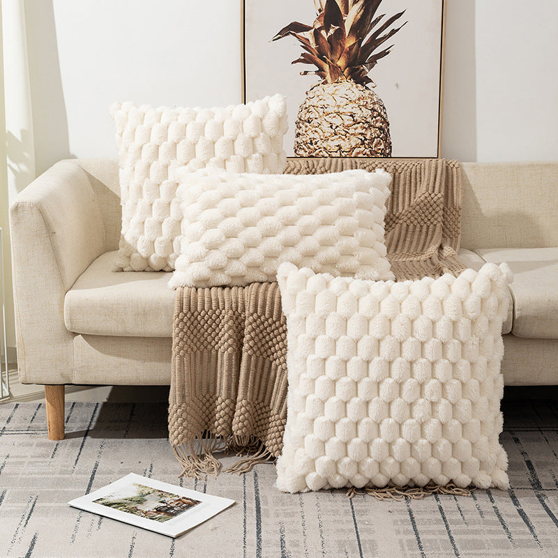 Woven fleece solid color waist pillow cover on a soft grey sofa in a cozy room

