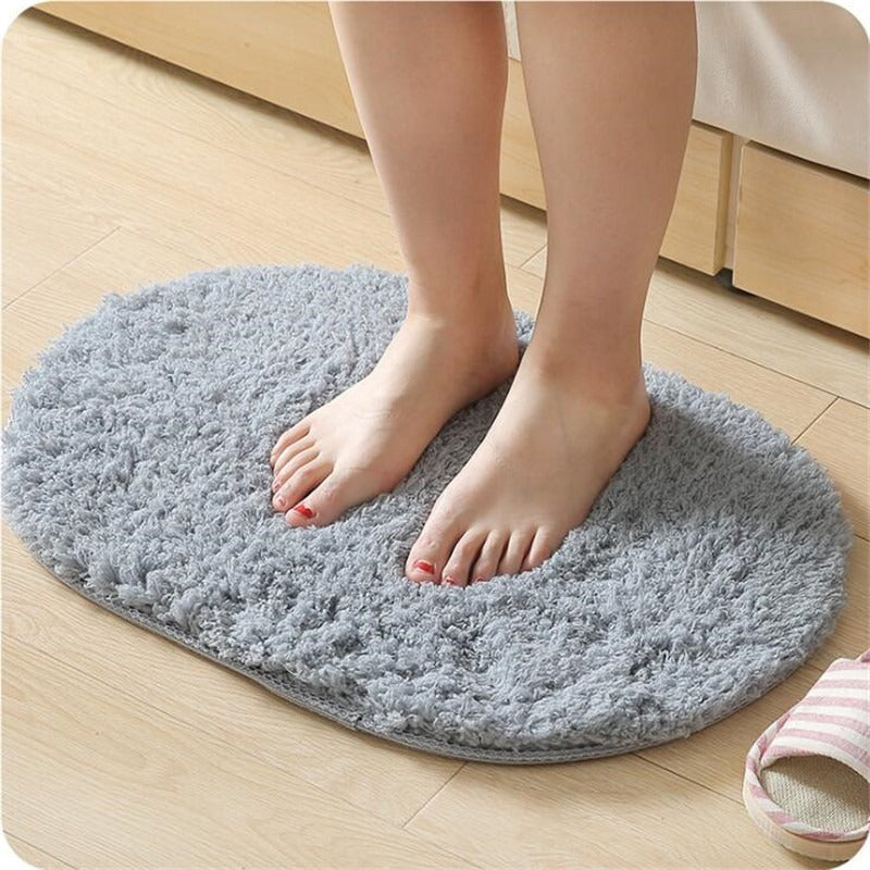 Oval-shaped absorbent carpet in a modern living room with light furniture and natural lighting

