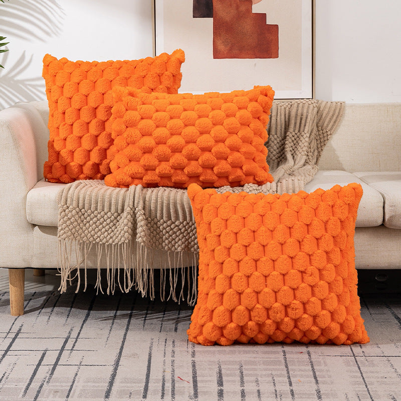 Woven fleece solid color waist pillow cover on a soft grey sofa in a cozy room

