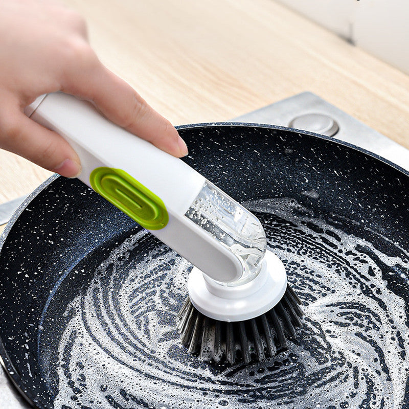 Multi-functional kitchen cleaning brush with long handle and liquid dispenser.