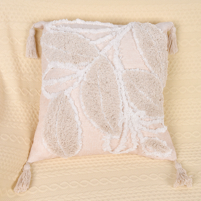 Tufted leaf design throw pillow on a neutral-toned sofa in a cozy living room

