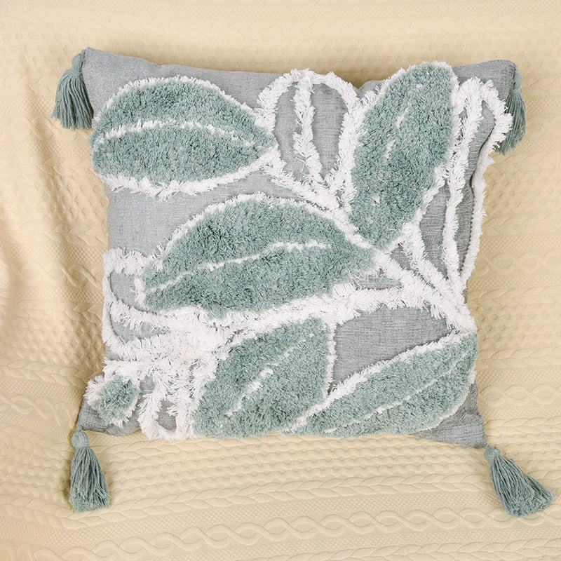 Tufted leaf design throw pillow on a neutral-toned sofa in a cozy living room

