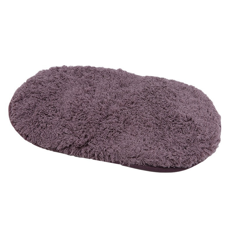 Oval-shaped absorbent carpet in a modern living room with light furniture and natural lighting


