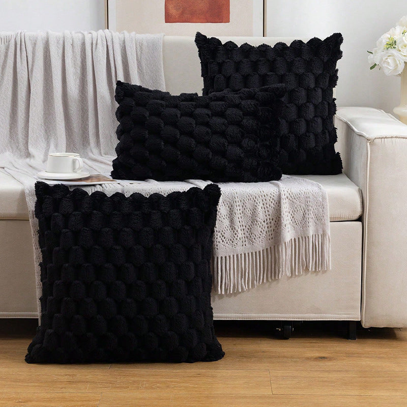 Woven fleece solid color waist pillow cover on a soft grey sofa in a cozy room

