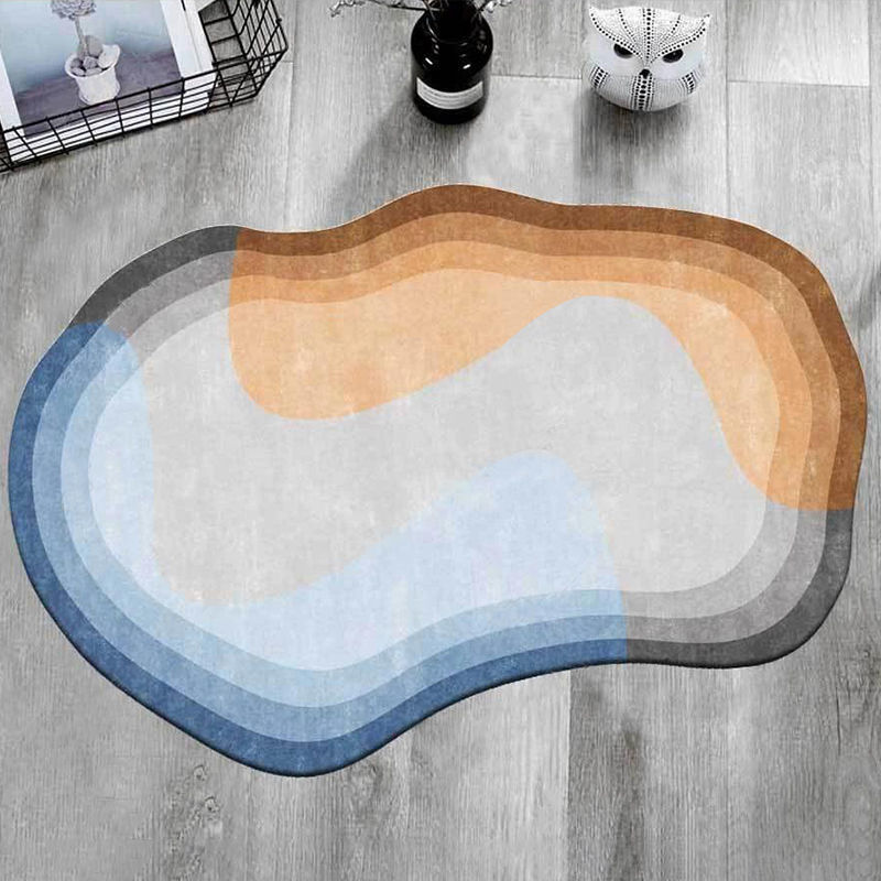 Irregular shaped carpet placed under a coffee table in a modern living room with artistic décor

