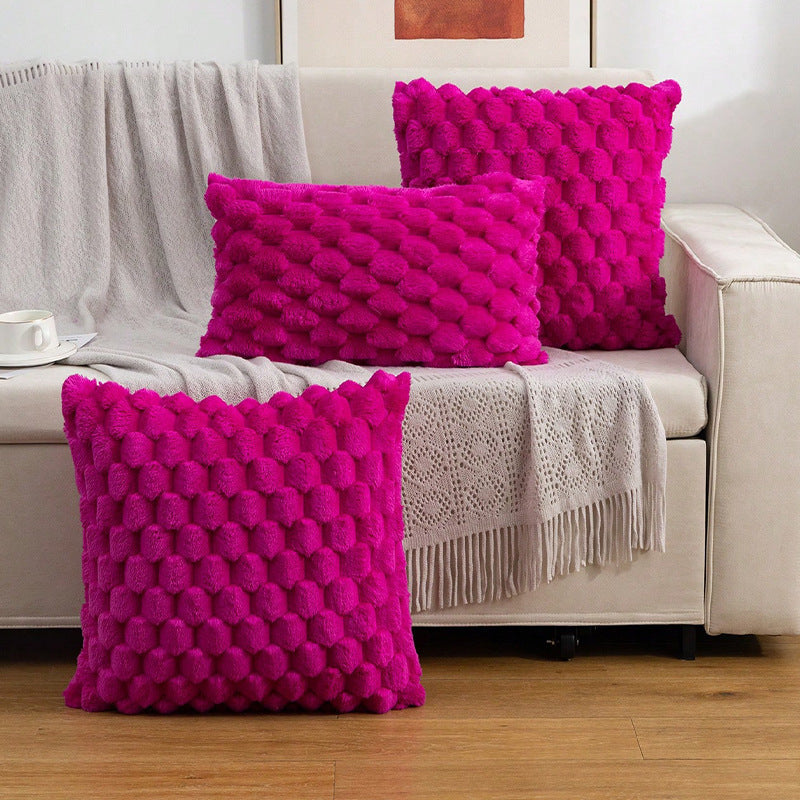 Woven fleece solid color waist pillow cover on a soft grey sofa in a cozy room


