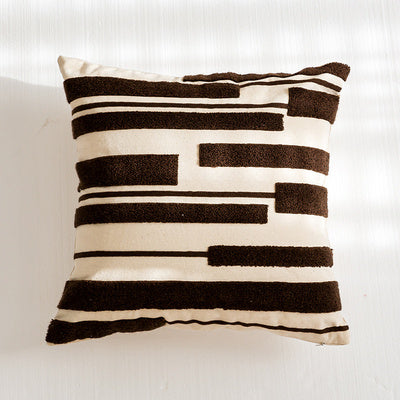 Nordic-style decorative cushion on a minimalist sofa with neutral tones


